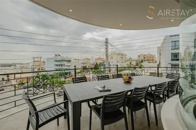 a table and chairs on a balcony with a view at Jaax Apartment Airport by Airstay in Spáta