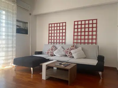 a living room with a couch and a coffee table at Cozy flat in the heart of Athens in Athens