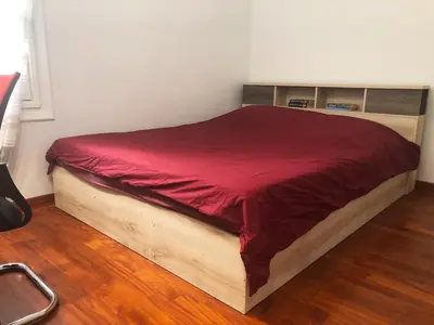 a bed with a red blanket on top of it at Cozy flat in the heart of Athens in Athens
