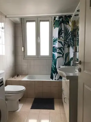 a bathroom with a tub and a toilet and a sink at Cozy flat in the heart of Athens in Athens