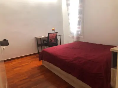 a bedroom with a bed and a desk with a chair at Cozy flat in the heart of Athens in Athens