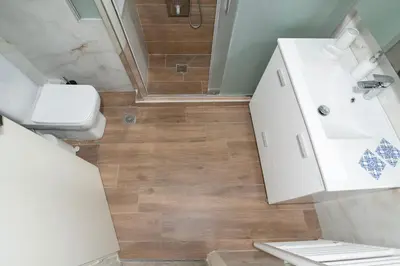 a bathroom with a toilet and a sink and a shower at AthensHomes Spacious Comfort Metro apt 3Br 2Ba in Athens