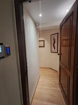 a hallway with an open door and a wooden floor at Elaine's Athens Riviera Studios in Athens