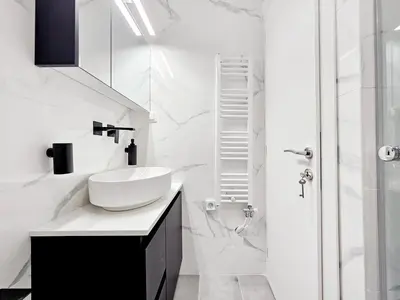 a white bathroom with a sink and a shower at Elaine's Athens Riviera Studios in Athens