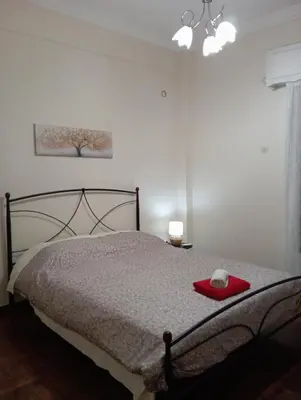 a bedroom with a bed with a red plate on it at Room Z for two 5' from metro in Athens