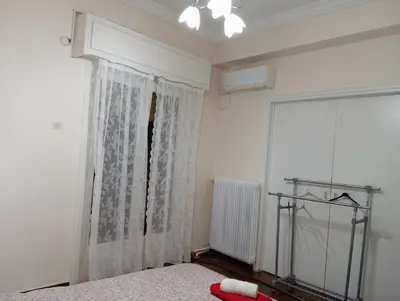a bedroom with a curtain and a window at Room Z for two 5' from metro in Athens