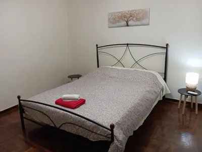 a bedroom with a bed with a red box on it at Room Z for two 5' from metro in Athens