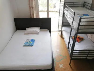 a small bedroom with two bunk beds and a window at SHARED ROOMS NEAR ACROPOLIS & MONASTIRAKi area in Athens
