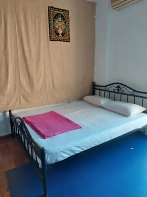 a bed with a black frame and a pink blanket on it at SHARED ROOMS NEAR ACROPOLIS & MONASTIRAKi area in Athens