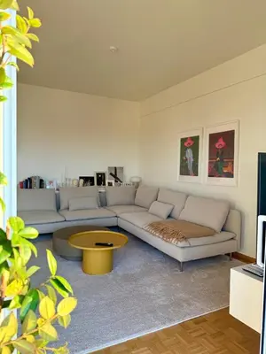 a living room with a couch and a coffee table at Sunny Downtown Glyfada Penthouse in Athens