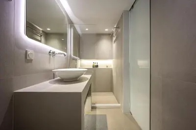 a bathroom with a white sink and a shower at Downtown Properties Loft 2 in Athens