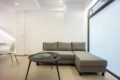 a living room with a couch and a table at Downtown Properties Loft 2 in Athens