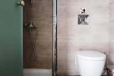 a bathroom with a toilet and a shower at Piraeus Port Hotel in Piraeus