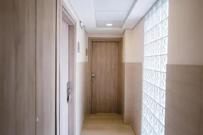a hallway with a wooden door in a room at Piraeus Port Hotel in Piraeus