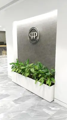 a sign on a wall with plants at Piraeus Port Hotel in Piraeus
