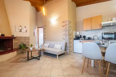 a kitchen and living room with a couch and a table at Fantasea Porto Rafti on the sea 15 minutes from the airport in Porto Rafti
