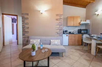 a living room with a couch and a table at Fantasea Porto Rafti on the sea 15 minutes from the airport in Porto Rafti