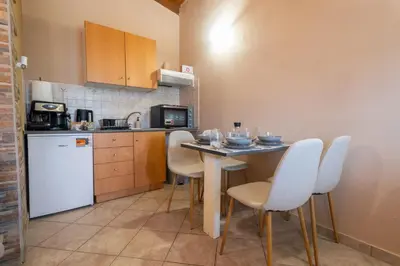 a kitchen with a table and chairs in a kitchen at Fantasea Porto Rafti on the sea 15 minutes from the airport in Porto Rafti