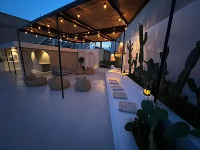 a patio with couches and cactuses on a house at The Rooftop in Athens