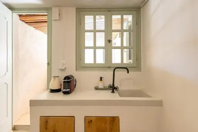a kitchen counter with a sink and a window at The Rooftop in Athens