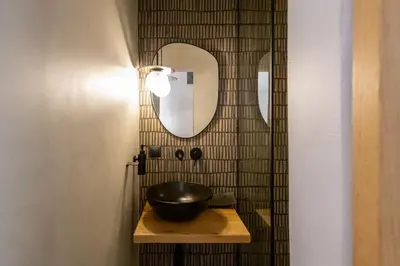 a bathroom with a bowl on a table with a mirror at The Rooftop in Athens