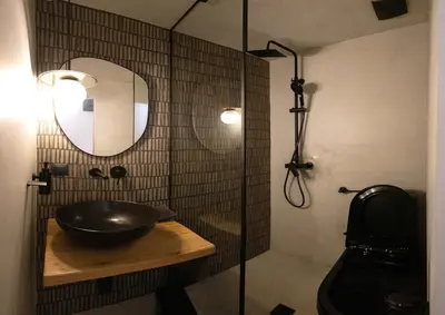 a bathroom with a sink and a glass shower at The Rooftop in Athens