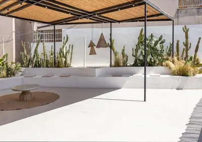 a room with plants and a table in the middle at The Rooftop in Athens