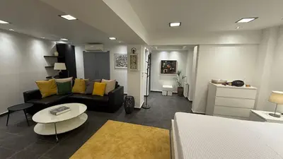 a living room with a couch and a table at Freddy enjoy kolonaki in Athens