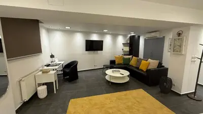 a living room with a couch and a table at Freddy enjoy kolonaki in Athens