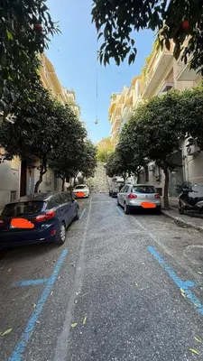 a street with cars parked on the side of the road at Freddy enjoy kolonaki in Athens