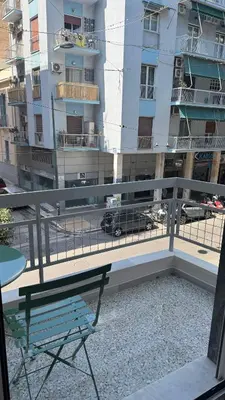 a balcony with a table and a bench and a building at Acropolis luxury home by Cleo in Athens