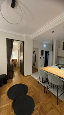 a living room with a table and chairs at Acropolis luxury home by Cleo in Athens