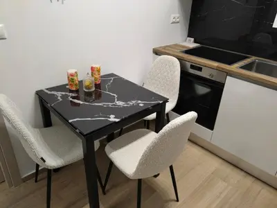 a black table and chairs in a kitchen at Cozy 1-Bedroom Flat in the Heart of Athens by ΜΡS in Athens