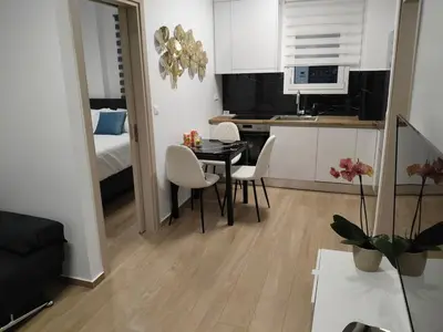 a small kitchen and dining room with a table and chairs at Cozy 1-Bedroom Flat in the Heart of Athens by ΜΡS in Athens