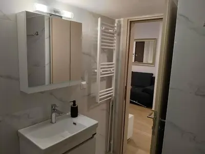 a white bathroom with a sink and a mirror at Cozy 1-Bedroom Flat in the Heart of Athens by ΜΡS in Athens