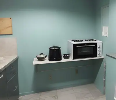 a kitchen with a stove and pots on a shelf at Panathenaic Athens Center Apartment in Athens