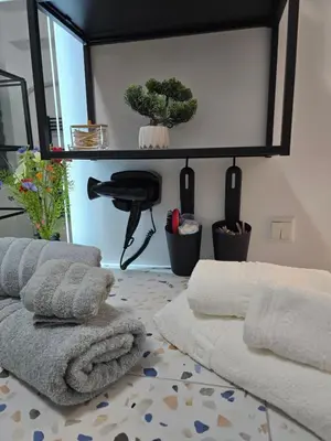 a room with towels and a mirror and plants at Kiki's comfort stay in West Athens in Athens