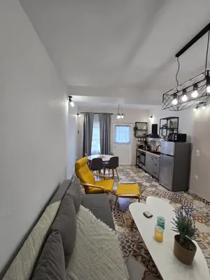 a living room with a couch and a table at Kiki's comfort stay in West Athens in Athens
