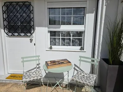 two chairs and a table in front of a door at Kiki's comfort stay in West Athens in Athens