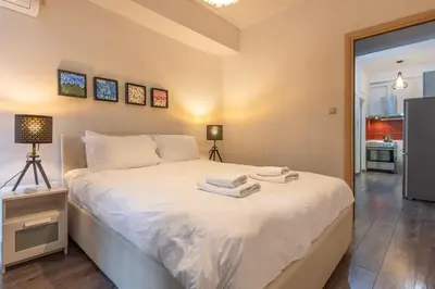 a bedroom with a white bed with towels on it at Industrial-Style Apt in Psyrri, Walk to Acropolis in Athens