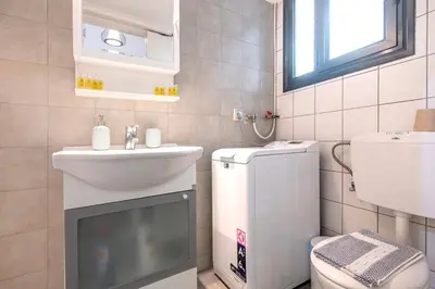 a small bathroom with a sink and a toilet at Industrial-Style Apt in Psyrri, Walk to Acropolis in Athens