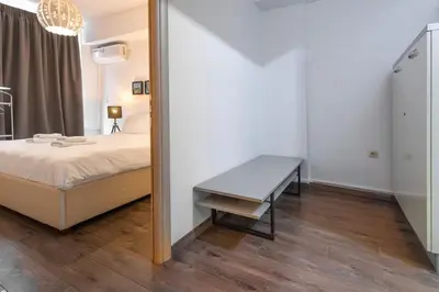 a bedroom with a bed and a table in a mirror at Industrial-Style Apt in Psyrri, Walk to Acropolis in Athens