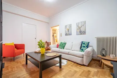 a living room with a couch and a table at Spacious 3-Bedroom Apartment in Neos Kosmos by ΜΡS in Athens