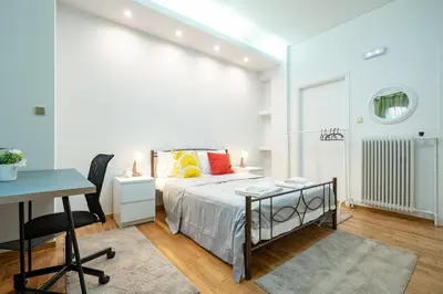 a bedroom with a bed and a desk and a table at Spacious 3-Bedroom Apartment in Neos Kosmos by ΜΡS in Athens