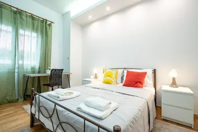 a bedroom with a bed with towels on it at Spacious 3-Bedroom Apartment in Neos Kosmos by ΜΡS in Athens