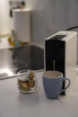 a coffee maker and a cup of coffee on a counter at Summer Vacation Home in Vouliagmeni for 4 by Filos Inc in Athens
