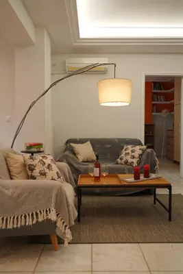 a living room with a couch and a coffee table at Summer Vacation Home in Vouliagmeni for 4 by Filos Inc in Athens