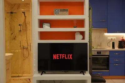 a tv in a kitchen with the words netflix at Summer Vacation Home in Vouliagmeni for 4 by Filos Inc in Athens