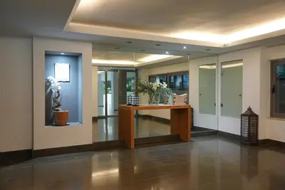 a lobby with a desk with flowers on it at Summer Vacation Home in Vouliagmeni for 4 by Filos Inc in Athens