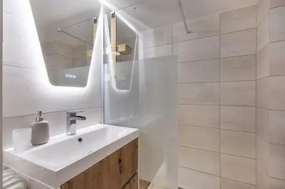 a white bathroom with a sink and a mirror at Viora - Stunning Deluxe Studio in Athens in Athens